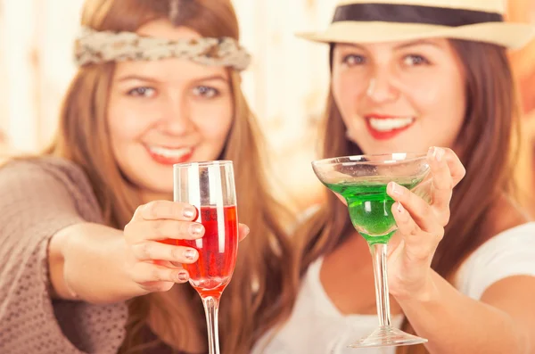 Two fun beautiful girls holding their cocktails — Stock Photo, Image