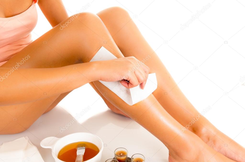 Beautiful young latin woman with silky skin, waxing her legs