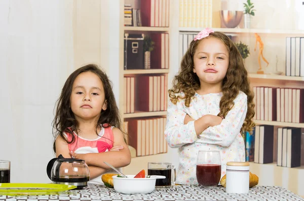 Two young preschooler girls refusing to eat