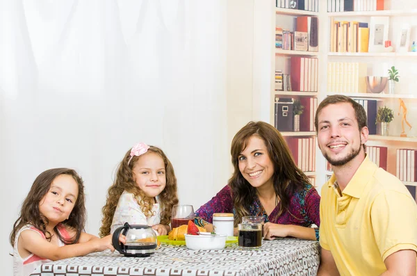 Happy young family having breakfast together — Stock Photo, Image