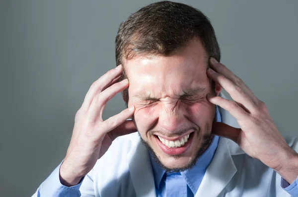 Closeup portrait of handsome young angry desperate doctor — Stock Photo, Image