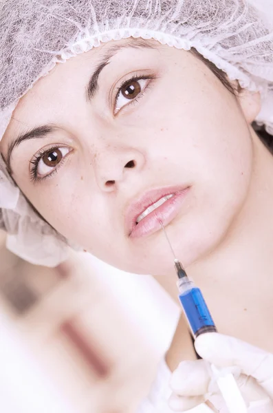 Close up portrait of girl getting injection in face — Stock Photo, Image