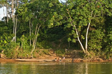 Unidentified local indigenous people next to Napo river in the rainforest, Yasuni National Park, Ecuador