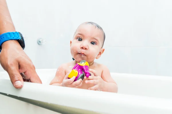 Sweet baby playing with toy during bath — Stock Photo, Image