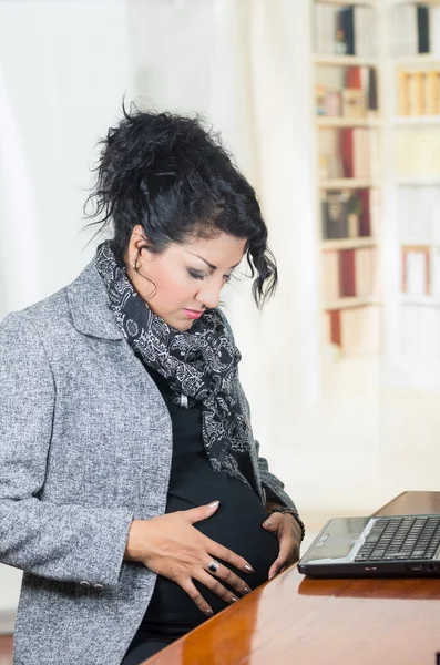 Pregnant hispanic woman wearing casual clothes at work — Stock Photo, Image