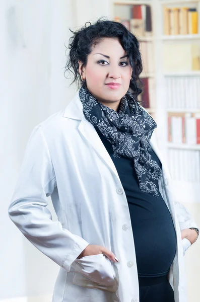 Pregnant hispanic woman wearing casual clothes at work — Stock Photo, Image