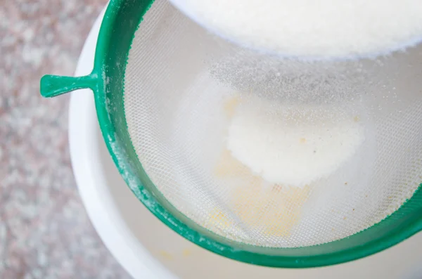 Sugar in colander — Stock Photo, Image