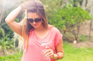 Woman model posing in green park
