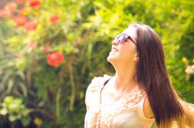 Woman model posing in green park