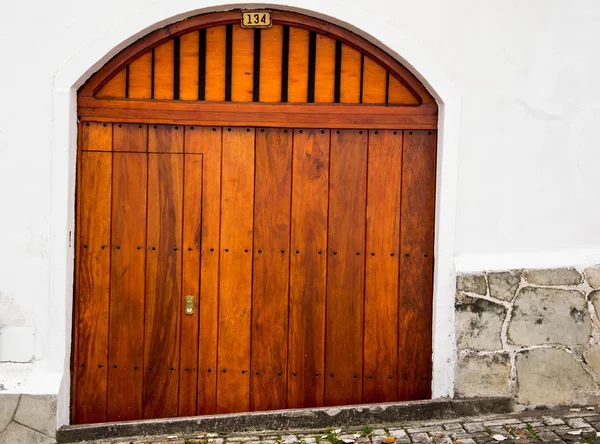 Nice wooden double gate with small arch and integrated entrance door — Stockfoto