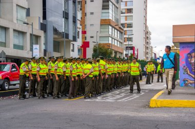 Policemen waiting for Pope Francis Popemobile motorcade comming as his first oficial visit  to Quito, Ecuador