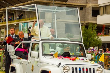 Front side angle Pope Francis motorcade driving through city crowds of people cheering to start off official South America tour his first stop Quito, Ecuador,
