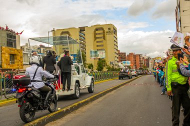 Pope Francis motorcade driving through city crowds of people cheering to start off official South America tour his first stop Quito, Ecuador, shot from behind vehicle