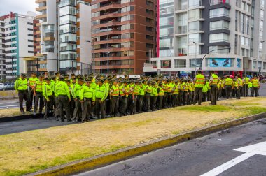 Policemen waiting for Pope Francis Popemobile motorcade coming as his first official visit  to Quito, Ecuador