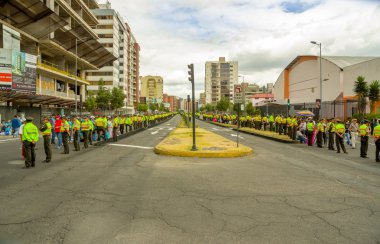 Quito city street closed off by long line police officers awaiting Pope Francis motorcade to arrive, shot from popemobile point of view