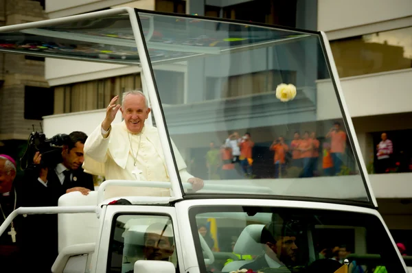Clear shot of Pope Francis standing on popemobile and waving in camera direction as motorcade drives through Quito city streets with crowds cheering — Stock Photo, Image