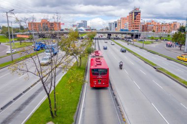 Büyük genel bakış kadeh ana yol portraing kırmızı toplu taşıma Transmilenio, arka plan tuğla kentsel binalar Bogota Kolombiya