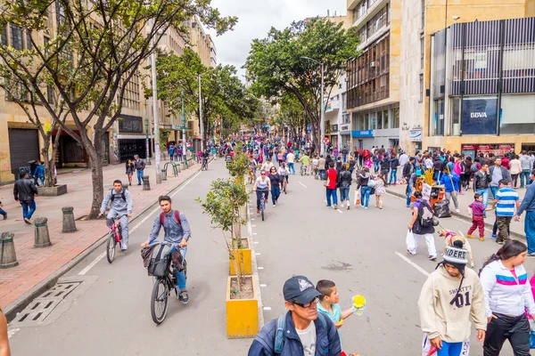 Unidentified hispanic pedestrians and cyclists moving through city street Candelaria area Bogota — Stock Photo, Image