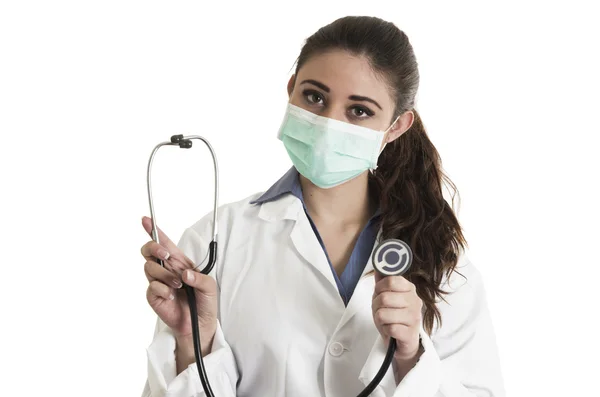 Young pretty female doctor wearing a mask and holding stethoscope — Stock Photo, Image