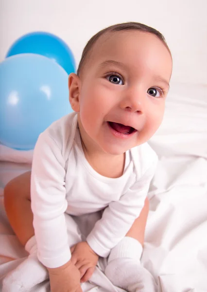 Cute amused infant boy with balloons — Stock Photo, Image