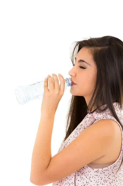 Beautiful young girl drinking water from a plastic bottle — Stock Photo, Image