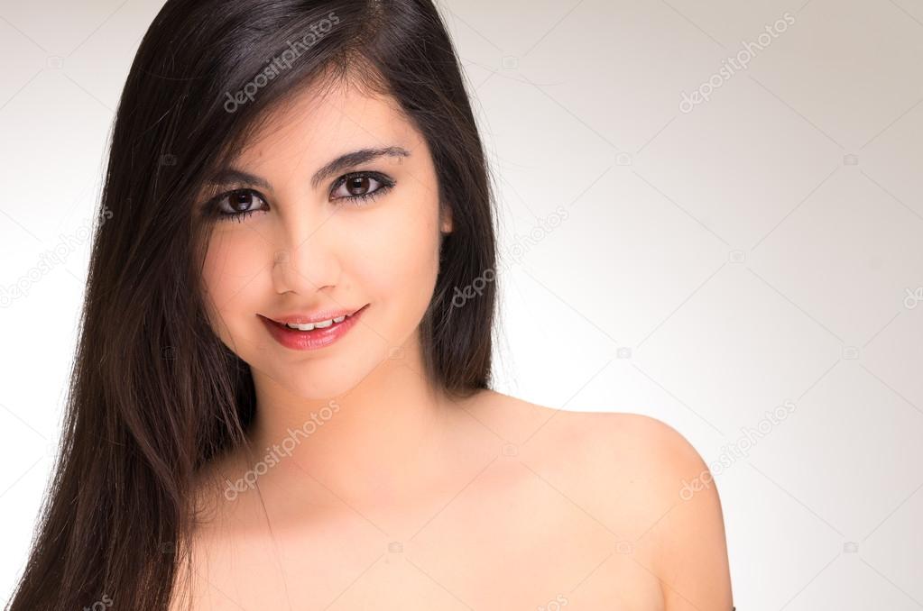 Closeup portrait of beautiful young brunette girl posing