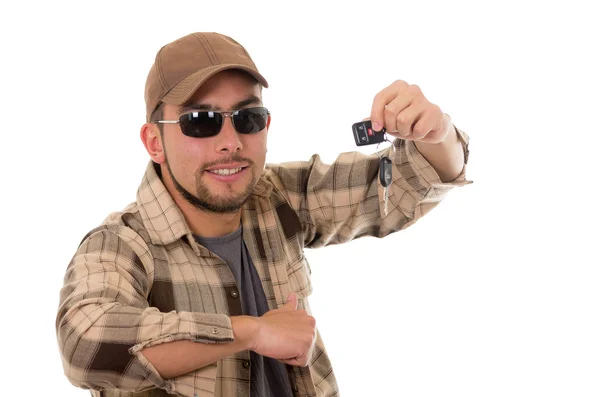 Happy young guy in flannel shirt and cap showing car keys — Stock Photo, Image