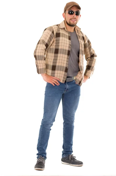 Latin man in flannel shirt cap and sunglasses standing fullbody — Stock Photo, Image