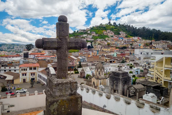 Stone cross decoration belonging to San Diego church with beautiful view showing old part of Quito background — Stock Photo, Image