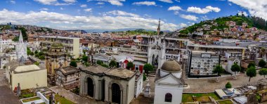Great colorful view over San Diego cemetary with typical catholic gravetones and spectacular overview of city including famous Panecillo mountain background