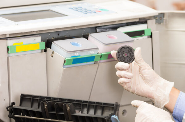 closeup shot technician fixing broken photocopier machine