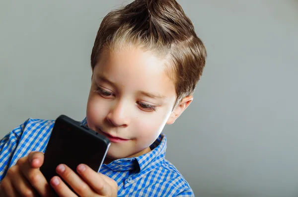 Schattige jongen met behulp van mobiele telefoon — Stockfoto