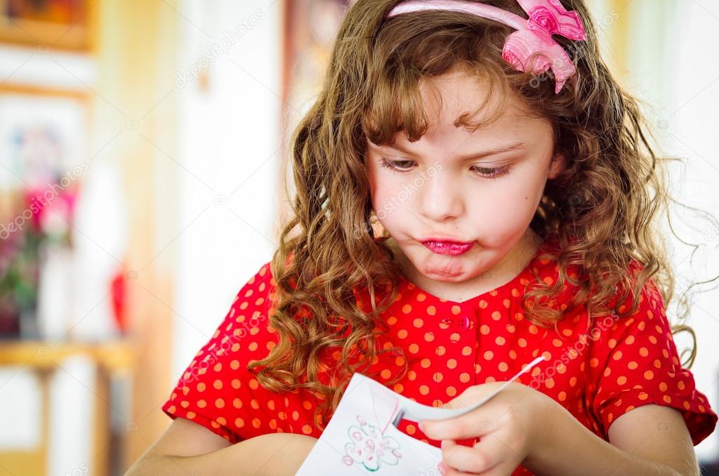 Curly little girl with scissors