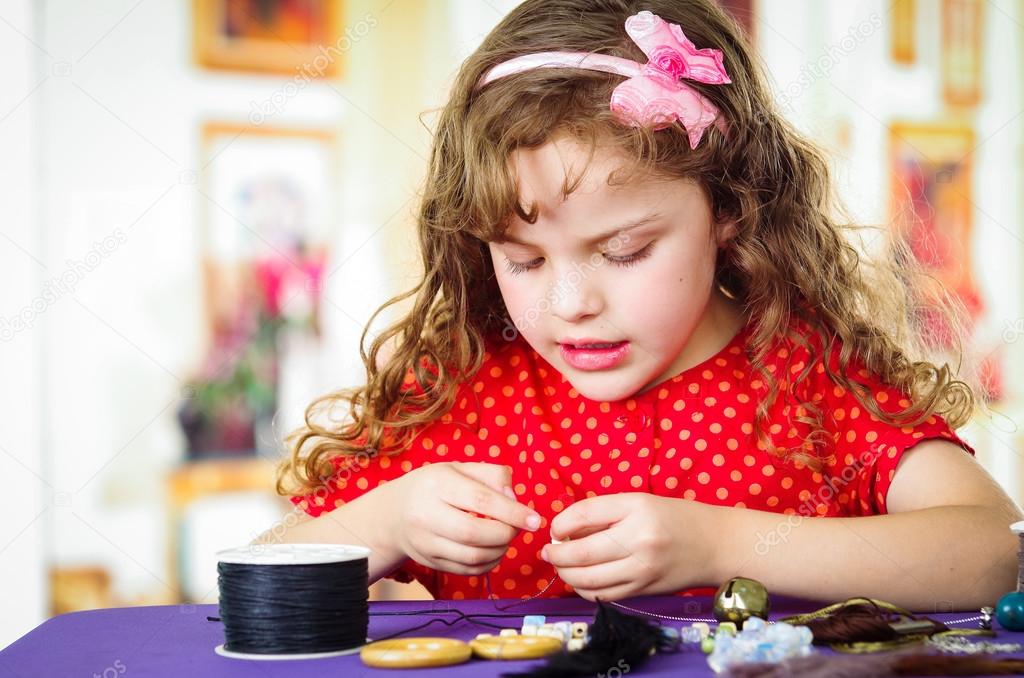 Adorable little girl making crafts