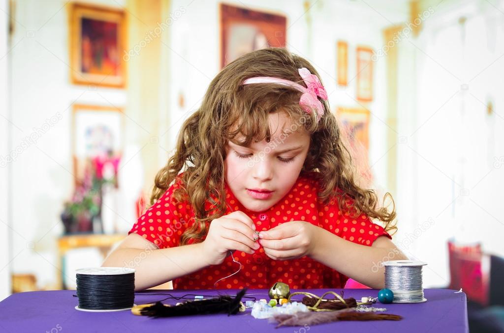 Adorable little girl making crafts