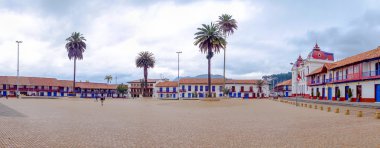 Panoramic view, historic city center Zipaquira, where is located the Cathedral of Diocesana surrounded by beautiful red, blue architecture with palm trees.