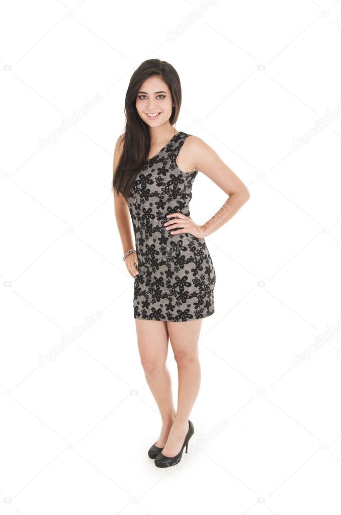 Beautiful young woman wearing a little black dress posing