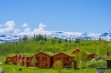 VALDRES, NORWAY - 6 JULY, 2015: Traditional Norwegian mountain cabins of wood with grassy rooftops sorrounded by stunning nature
