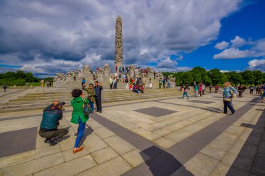 OSLO, NORWAY - 8 JULY, 2015: Famous monument Monolitten located centrally in Vigelandsparken sorrounded by other sculptures and beautiful green vegetation