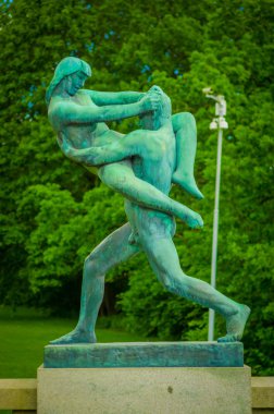 OSLO, NORWAY - 8 JULY, 2015: Various nude sculptures in different positions as part of famous Vigelandsparken on a beautiful summer day
