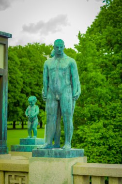 OSLO, NORWAY - 8 JULY, 2015: Various nude sculptures in different positions as part of famous Vigelandsparken on a beautiful summer day