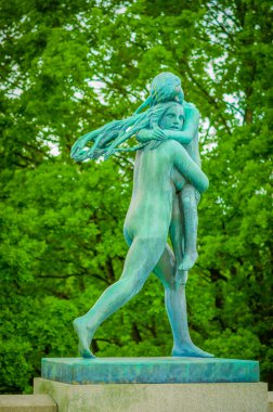 OSLO, NORWAY - 8 JULY, 2015: Various nude sculptures in different positions as part of famous Vigelandsparken on a beautiful summer day