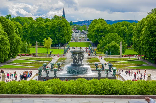 OSLO, NORWAY - 8 JULY, 2015: Big beautiful waterfall fountain located in Vigelandsparken sorrounded by charming pathways and green vegetation, shot from slightly above angle — Stock Fotó