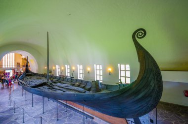 OSLO, NORWAY - 8 JULY, 2015: Beautiful preservation of Osebergskipet as presented in the viking museum at Bygdoy, shot from slightly above angle clipart