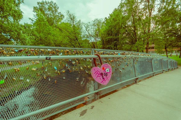 OSLO, NORWAY - 8 JULY, 2015: Alongside Akerselva river passing through city, bridge with many locks hooked as declarations for love — Stok fotoğraf