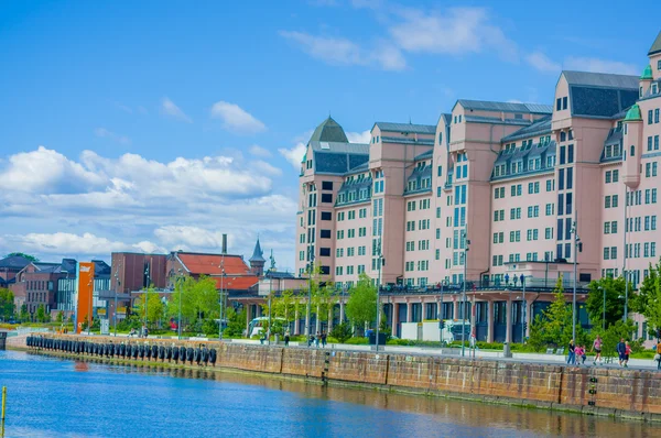 OSLO, NORWAY - 8 JULY, 2015: Beautiful typical european architecture pink office building on the waterfront. Famous national newspaper Dagbladet has its offices here.