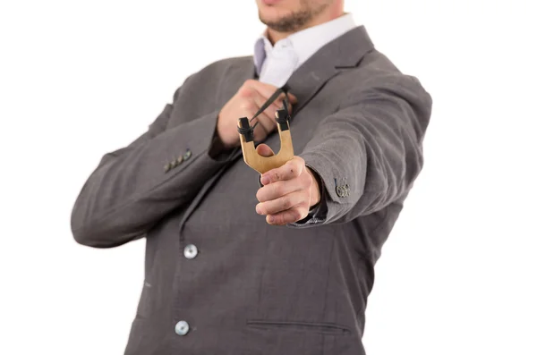 Handsome buisness man concentrated aiming a slingshot isolated over white background — 图库照片