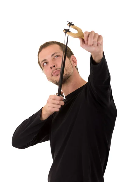 Hansome man concentrated aiming a slingshot isolated over white background — Stockfoto