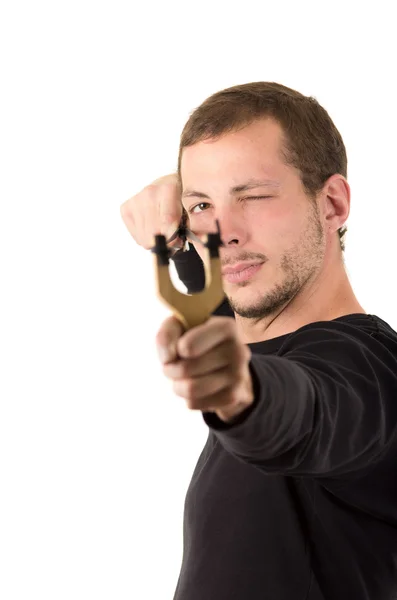 Hansome man concentrated aiming a slingshot isolated over white background — стокове фото