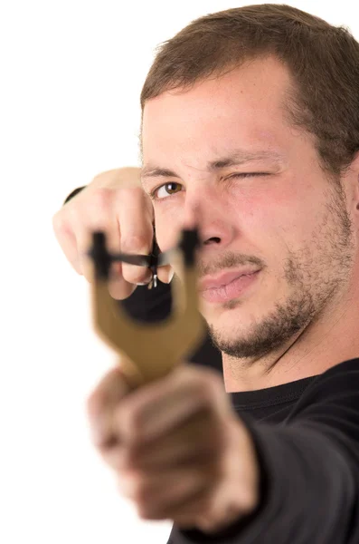 Hansome man concentrated aiming a slingshot isolated over white background — Φωτογραφία Αρχείου